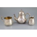 A Victorian engine turned silver three piece tea set by Richards & Brown, of baluster form, with