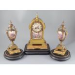 A 19th century French ormolu and enamelled porcelain clock garniture, the eight day clock with