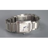 A lady's modern stainless steel Cartier Tank quartz wrist watch with diamond set numerals, with