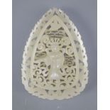 A Chinese pale celadon jade plaque, in Tang dynasty style, carved in relief and openwork with a
