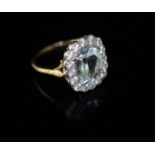 A modern 18ct gold, aquamarine and diamond cluster ring, size O/P, gross 5.5 grams.CONDITION: A