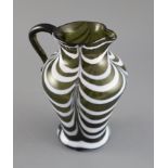 A George III green and white feather trailed glass jug, c.1800, applied scrolled handle, 19cm