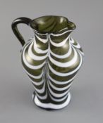 A George III green and white feather trailed glass jug, c.1800, applied scrolled handle, 19cm