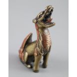 A Chinese bronze 'qilin' scroll weight, 17th century, with remnants of polychrome decoration 8cm