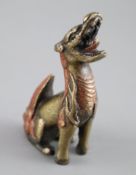 A Chinese bronze 'qilin' scroll weight, 17th century, with remnants of polychrome decoration 8cm