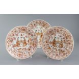 A set of three Chinese rouge de fer moulded dishes, Kangxi period, each painted with two ladies