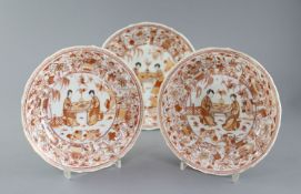 A set of three Chinese rouge de fer moulded dishes, Kangxi period, each painted with two ladies