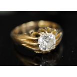 An early 20th century gold and old cushion cut claw set solitaire diamond ring, with fluted