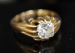 An early 20th century gold and old cushion cut claw set solitaire diamond ring, with fluted