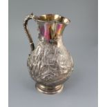 A large Victorian silver baluster hot water jug, by Robert Hennell IV, embossed with Scottish