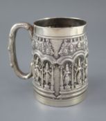 A late 19th century Indian repousse silver mug by P. Orr & Sons, Madras, decorated with figures in a