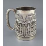 A late 19th century Indian repousse silver mug by P. Orr & Sons, Madras, decorated with figures in a