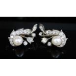 A pair of white gold, cultured pearl and diamond cluster set scroll earrings, 27mm, gross 10 grams.