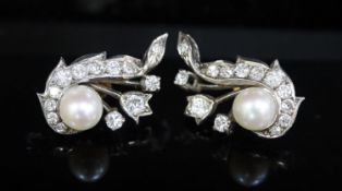 A pair of white gold, cultured pearl and diamond cluster set scroll earrings, 27mm, gross 10 grams.