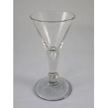 A balustroid type wine glass, c.1740, the trumpet shaped bowl above a teardrop stem and teared basal