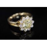 A modern 18ct gold and diamond cluster ring, the central fancy yellow round cut stone weighing