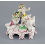 A Vauxhall porcelain group of two Bacchanalian cherubs and a goat, c.1760-5, on a scrollwork base,