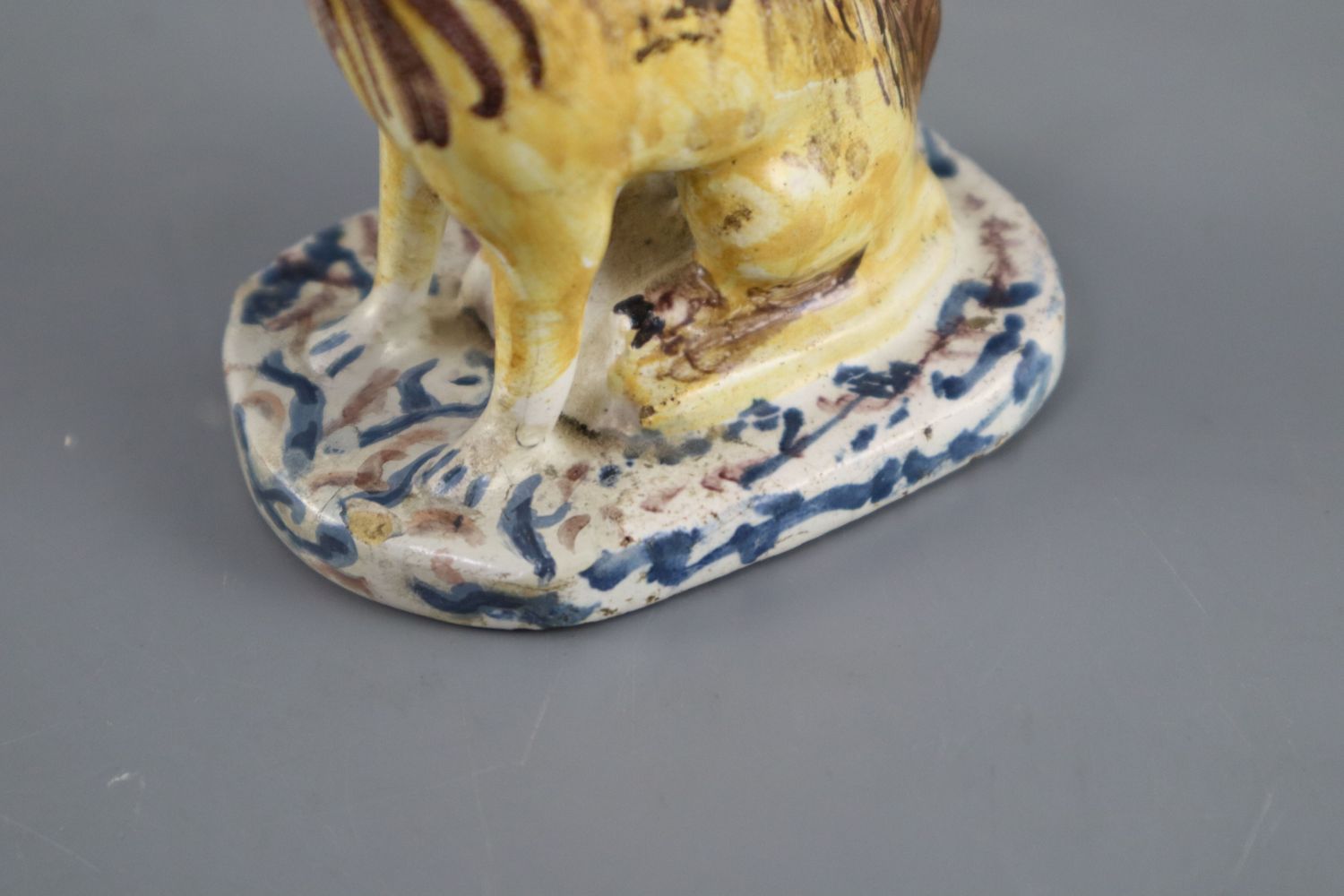 A Continental faience model of a seated dog, mid 18th century, possibly Brussels,CONDITION: - Image 3 of 6