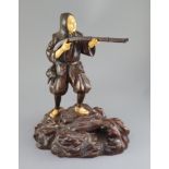 A good Japanese bronze and ivory okimono of a huntsman, Meiji period, the huntsman aiming his musket
