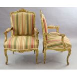 A pair of French gilt beech fauteuils, with moulded foliate scroll carved frames and cabriole
