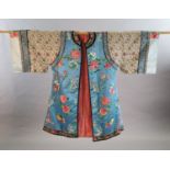 A Chinese embroidered silk robe, late 19th/early 20th century, embroidered with flowers, fruit and