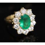 A modern 18ct gold, emerald and diamond oval cluster ring, size N, gross 8.3 grams.CONDITION: