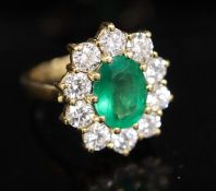 A modern 18ct gold, emerald and diamond oval cluster ring, size N, gross 8.3 grams.CONDITION: