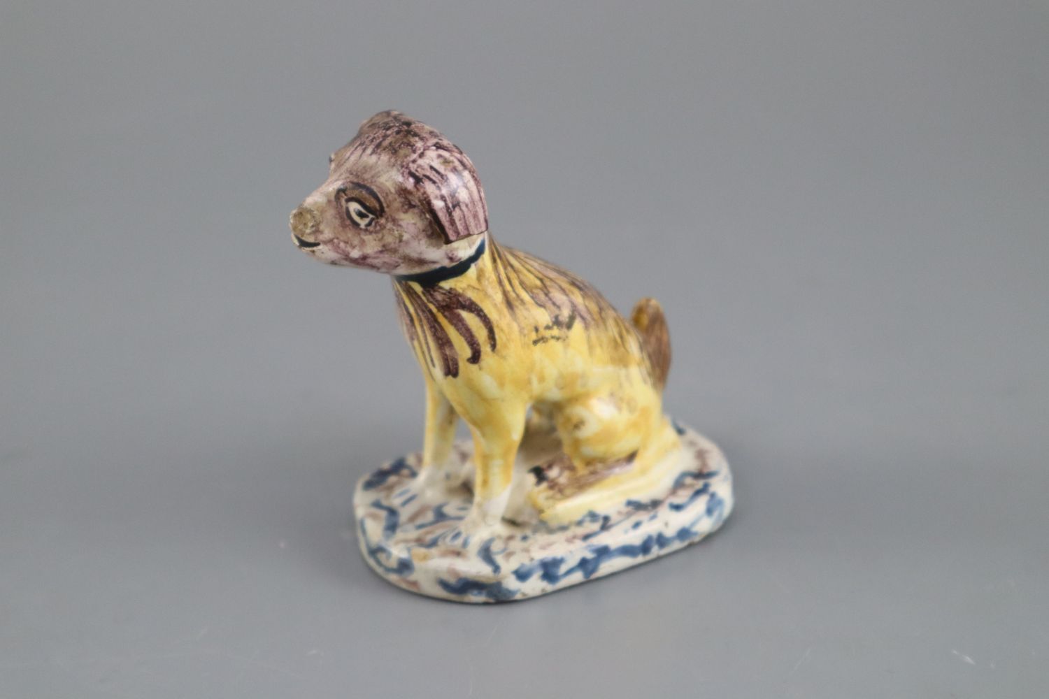 A Continental faience model of a seated dog, mid 18th century, possibly Brussels,CONDITION: - Image 2 of 6