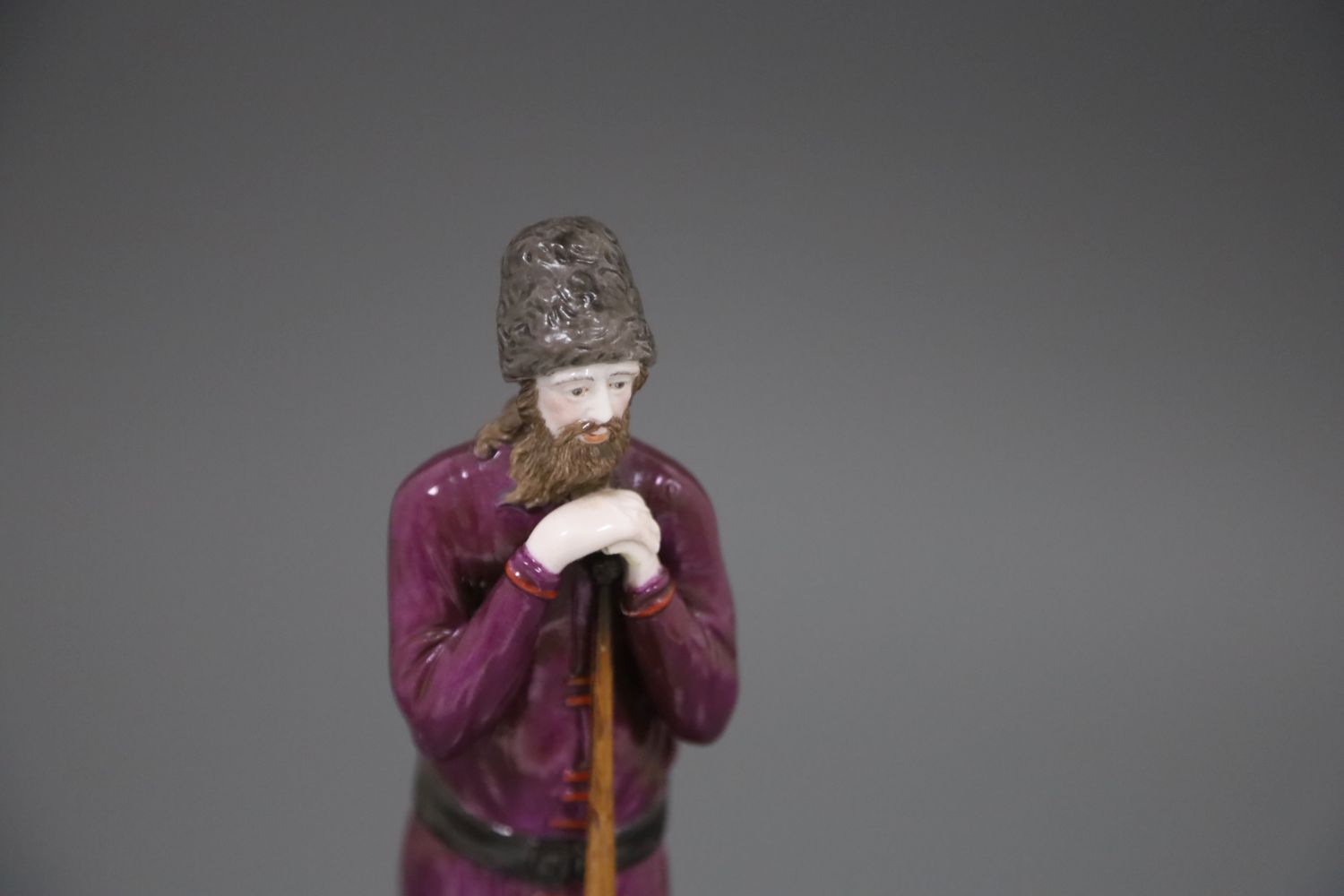 A Russian Gardner porcelain figure of a man holding a staff, mid 19th century, wearing traditional - Image 5 of 7