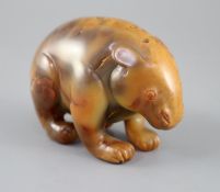 A Chinese chalcedony figure of a standing bear, the stone with natural inclusions and mottled