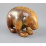 A Chinese chalcedony figure of a standing bear, the stone with natural inclusions and mottled