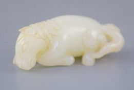 A Chinese white jade group of a recumbent horse and boy, the stone of good even tone with a small