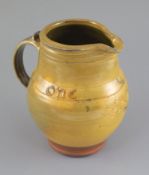 Bernard Howell Leach (1887-1979). A mustard-glazed slipware jug, 'one & all' and sgraffito