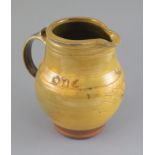 Bernard Howell Leach (1887-1979). A mustard-glazed slipware jug, 'one & all' and sgraffito