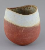 John Ward (b.1938). A hand-built stoneware vase, with asymmetric rim, rust graduating to duck egg