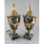 A pair of early 20th century ormolu green marble table lamps, with ovular form with mask lug handles