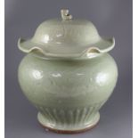 A large Chinese celadon jar and cover, Ming dynasty or later, the lotus leaf shaped cover above a