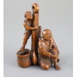 A Japanese boxwood okimono of two sailors and an anchor, Meiji period, one figure clambering on