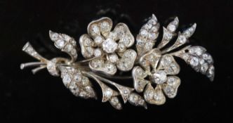 A Victorian gold, silver and graduated old round and cushion cut diamond set trembleuse floral spray