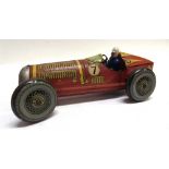 A METTOY TINPLATE RACING CAR yellow and red, racing number '7', with a clockwork motor, steerable