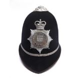 A BRITISH TRANSPORT POLICE CONSTABLE'S HELMET complete with helmet plate and chin strap.