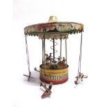 A TINPLATE FAIRGROUND SWING-BOAT CAROUSEL possibly German, with a lever-operated spring-driven