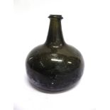 A LATE 18TH CENTURY ONION SHAPED WINE BOTTLE of squat form, olive green, 15.5cm high. Note: Dug up