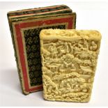 A CHINESE EXPORT IVORY CARD CASE intricately carved with finely detailed scenes of figures and