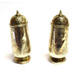 A PAIR OF VICTORIAN SILVER PEPPERETTES of tapered cylindrical form with engraved floral decoration