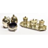 A SILVER THREE PIECE CONDIMENT SET AND TRAY of lighthouse form with pierced decoration, with