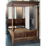 AN OAK FOUR POSTER BED with guilloche frieze, spirally turned uprights, the headboard with linen