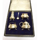 A BOXED FOUR PIECE CONDIMENT SET AND SALT SPOON comprising two salts, a pepperette and mustard of