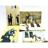 AFTER BANKSY Five canvas prints, four of them 25cm x 45cm and one 23cm x 30.5cm.