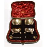 A CASED SET OF A PAIR OF SILVER NAPKIN RINGS, SILVER SALTS AND SALT SPOONS of plain circular form,